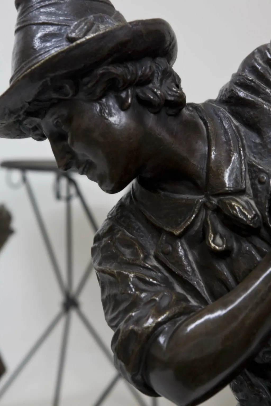 antique sculpture with detailed clothing and hat, artistic environment.