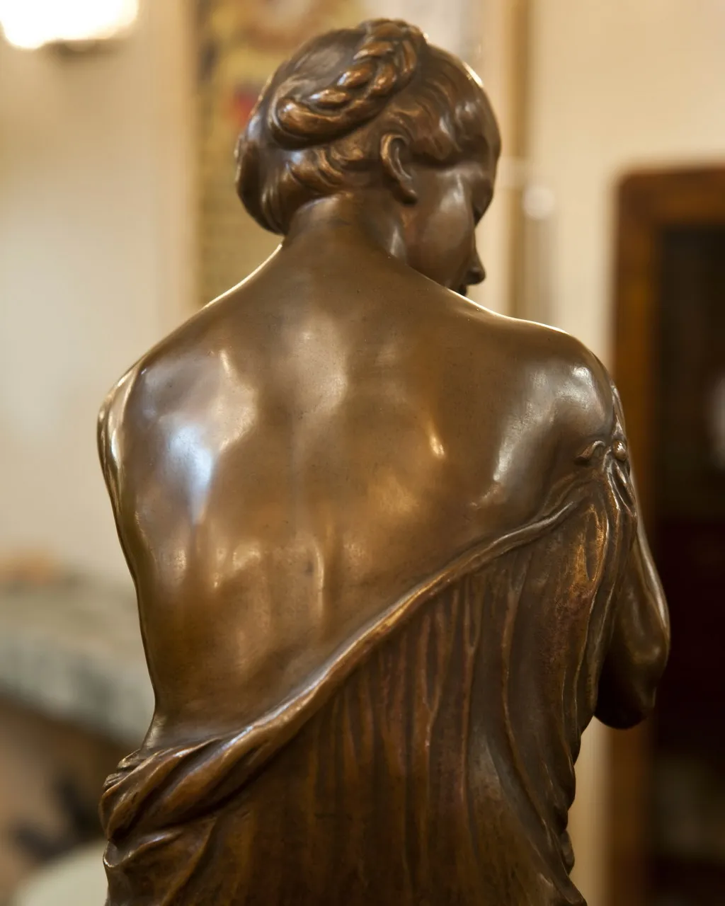 antique sculpture featuring detailed hair and dress