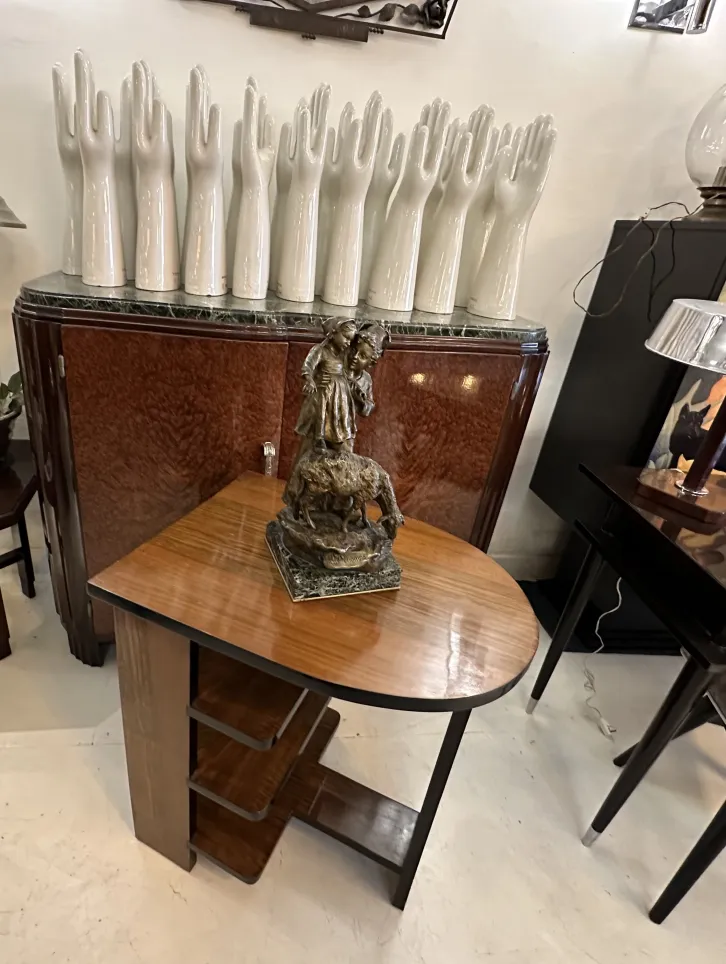 Antique sculpture of a figure on horseback in a stylish setting.