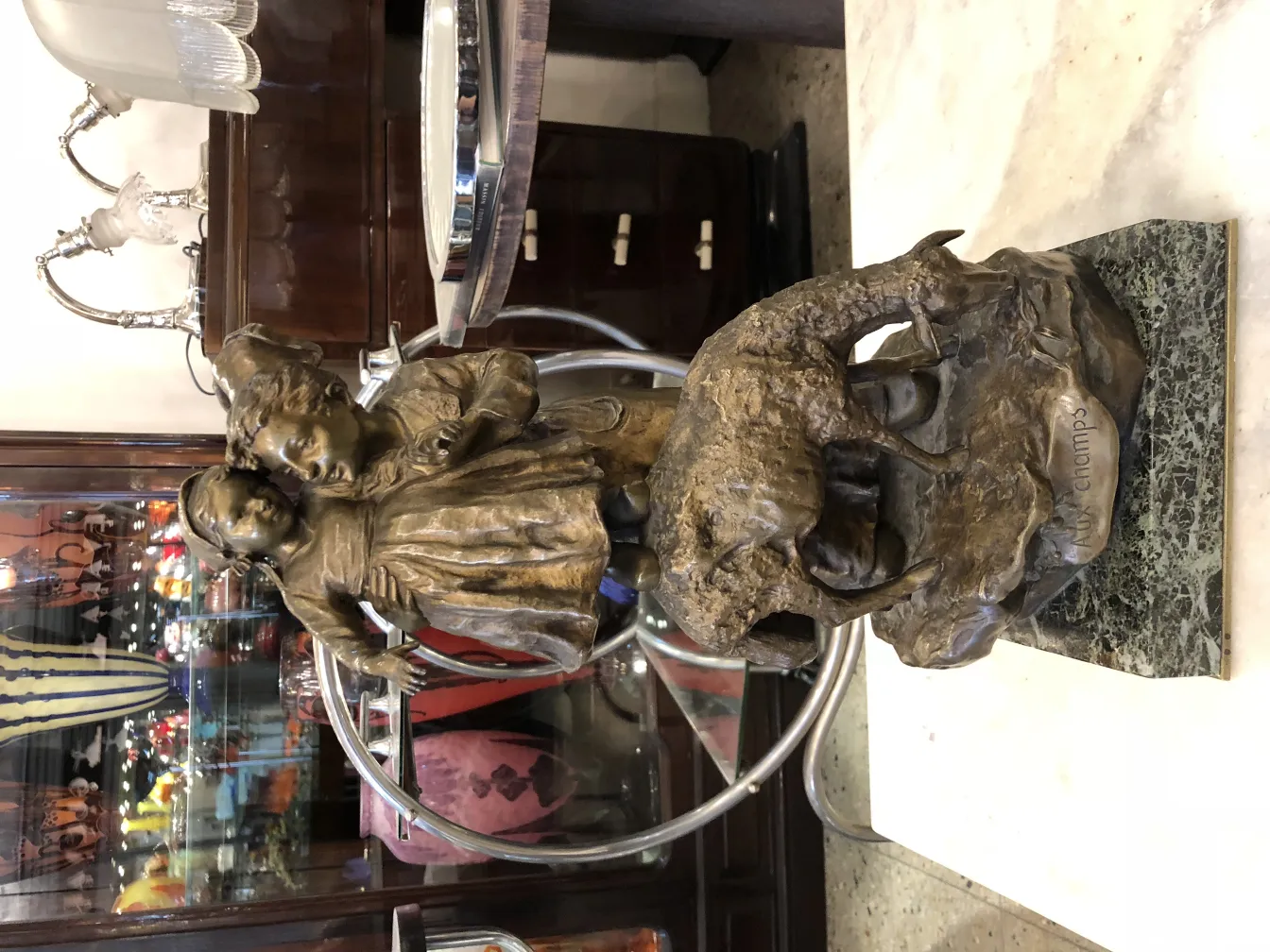 antique sculpture featuring children and an elephant in charming setting