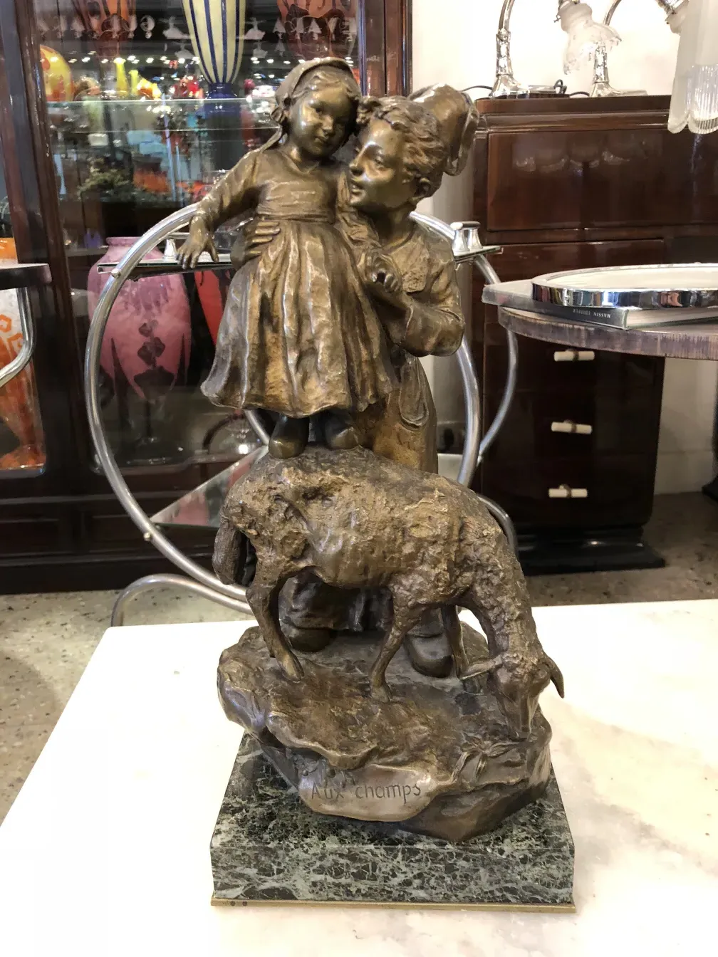 Antique sculpture by Giuseppe D'aste featuring boy and girl, with animal in background.
