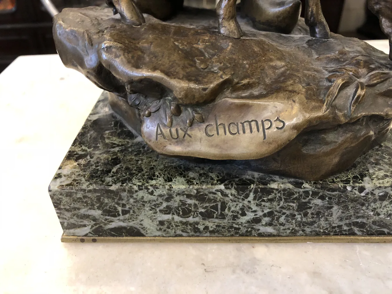 antique sculpture with aux champs inscription, decorative background