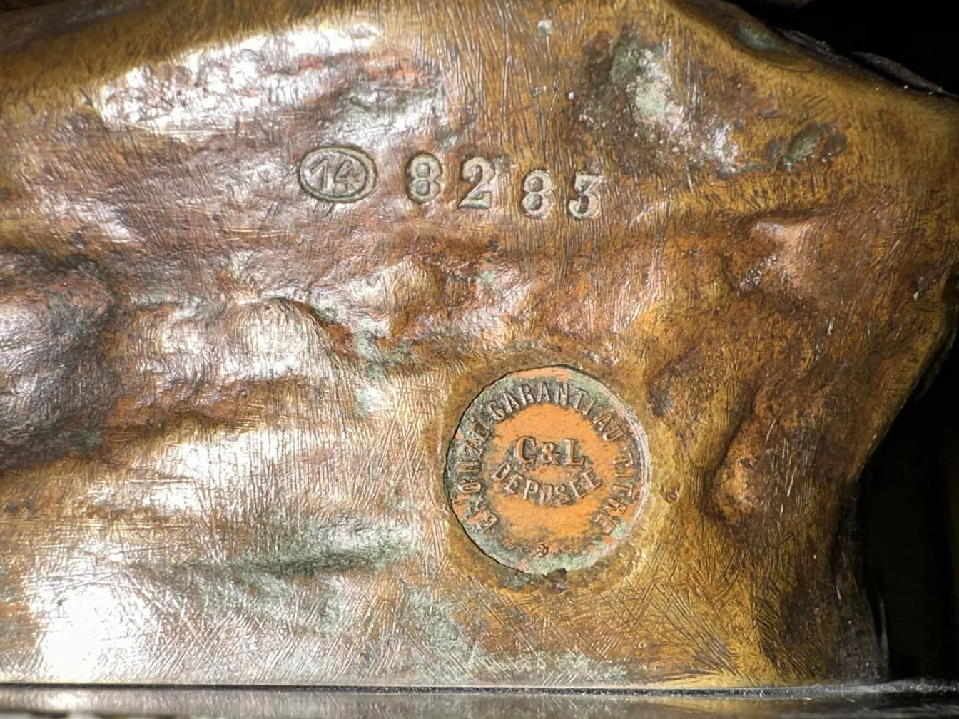 antique sculpture with interesting details and signature