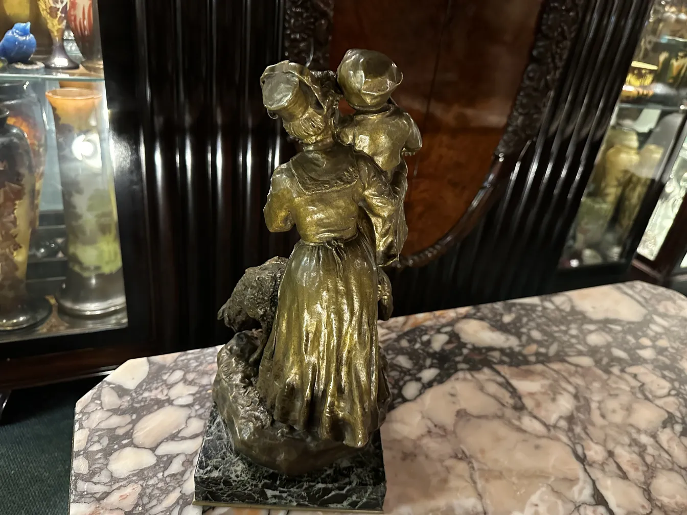 ancient sculpture with golden details, depicting women and children