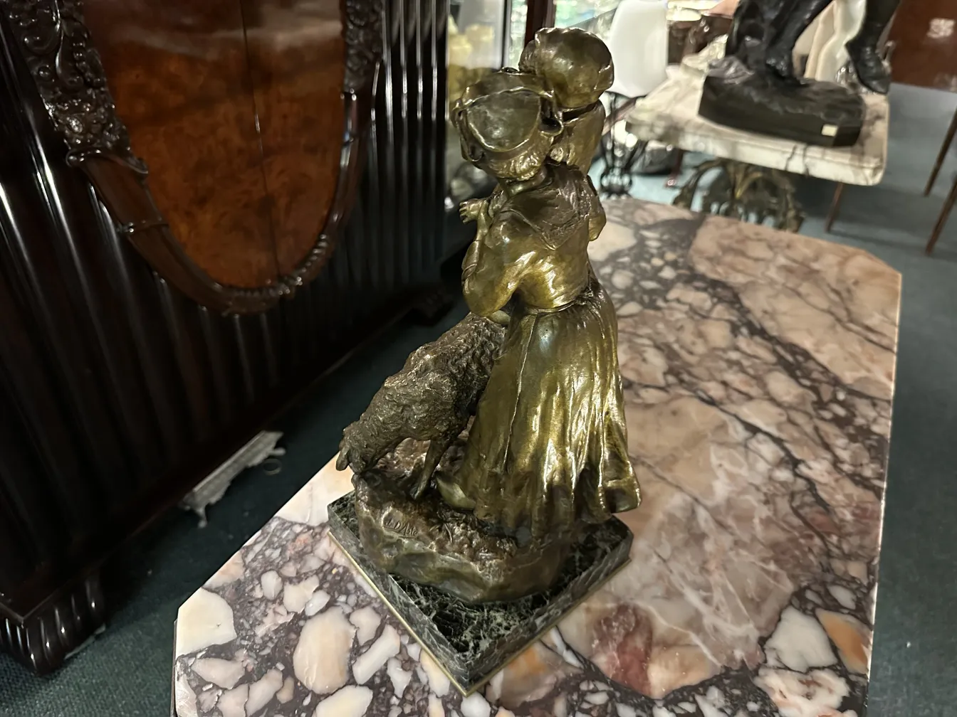 antique sculpture featuring female figure in warm setting