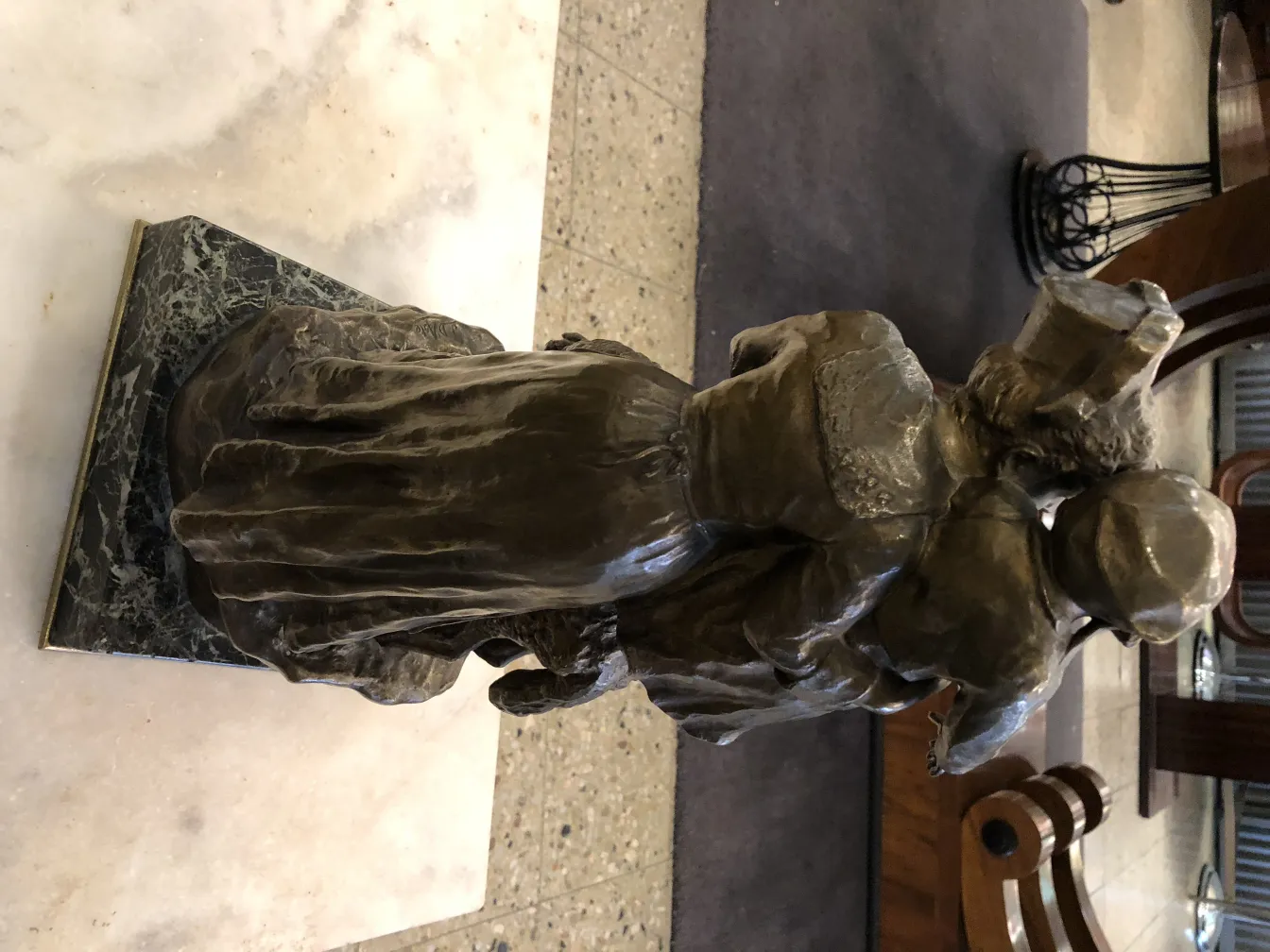 antique sculpture of a couple in a cozy setting