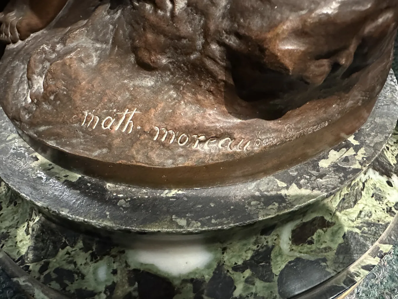 detail of an ancient sculpture with signature of mathurin moreau
