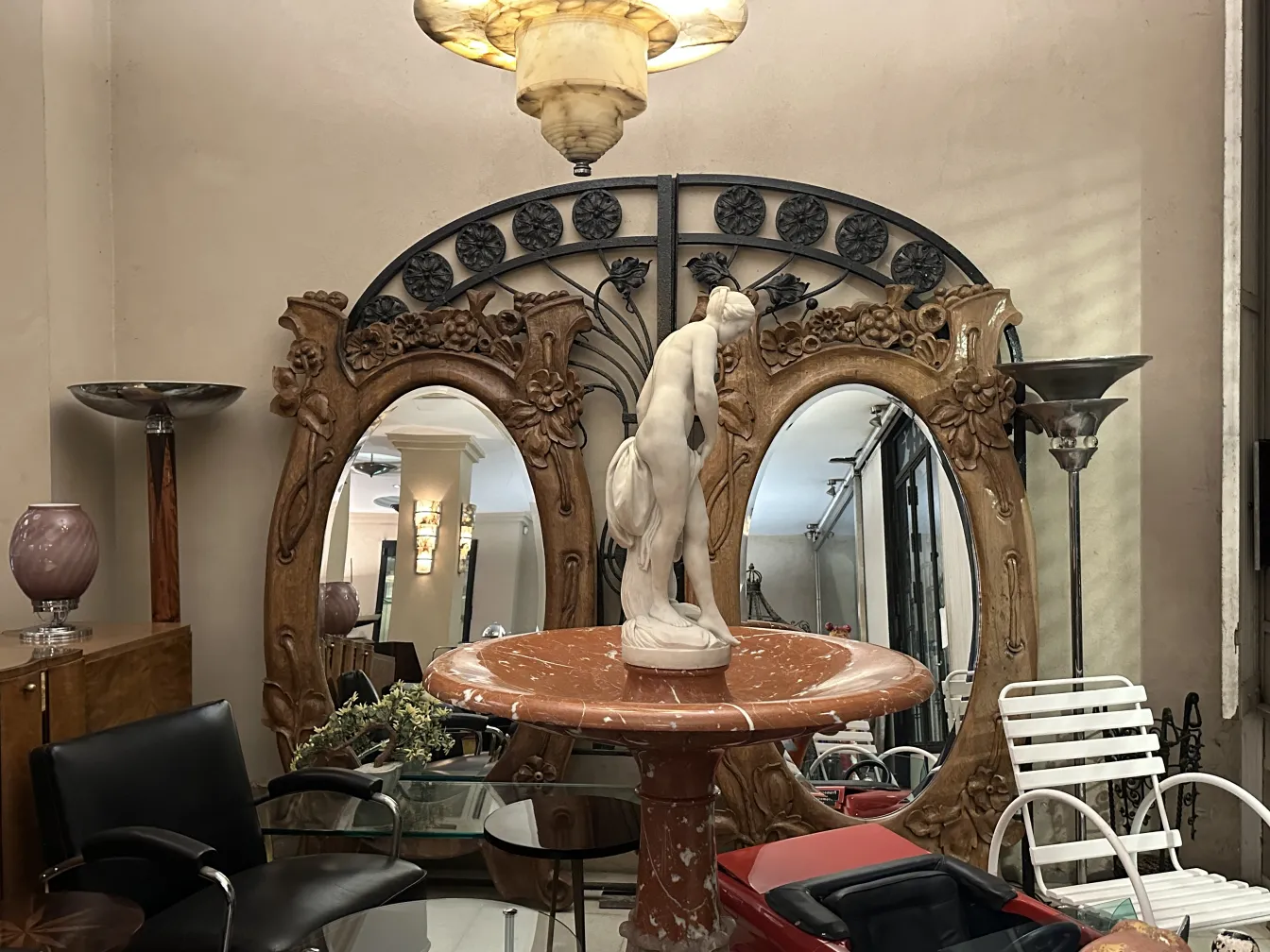 scultura antica su un piedistallo, circondata da elementi decorativi