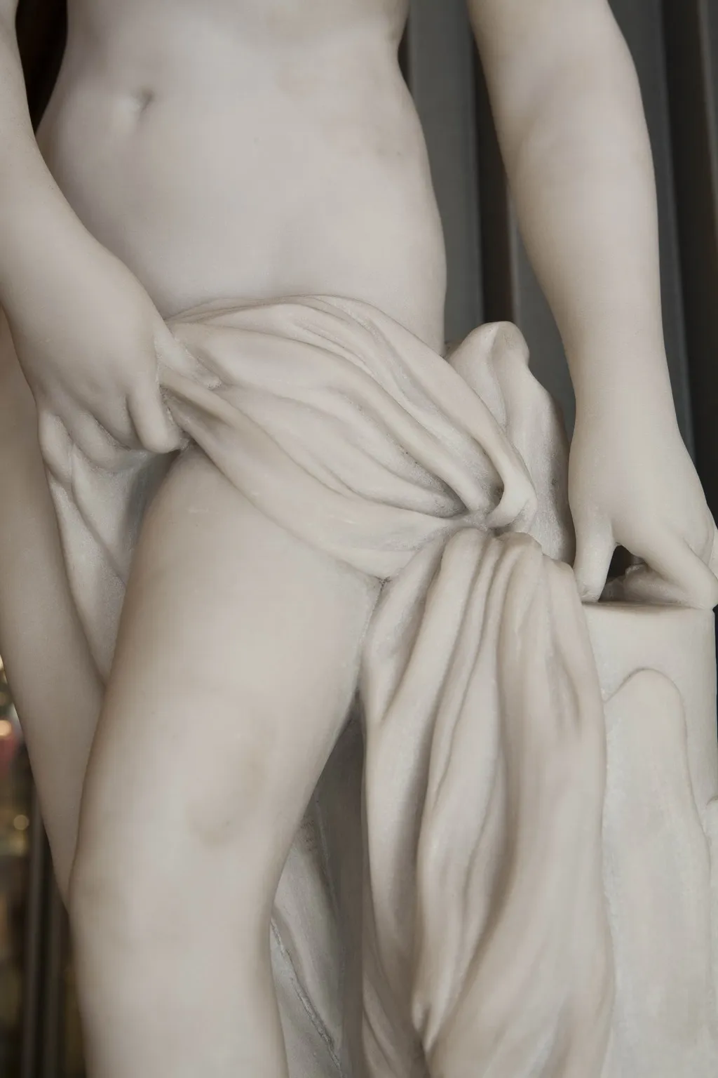 Antique sculpture of a human figure with detailed drapery