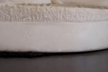 Antique sculpture with visible inscription on the base.