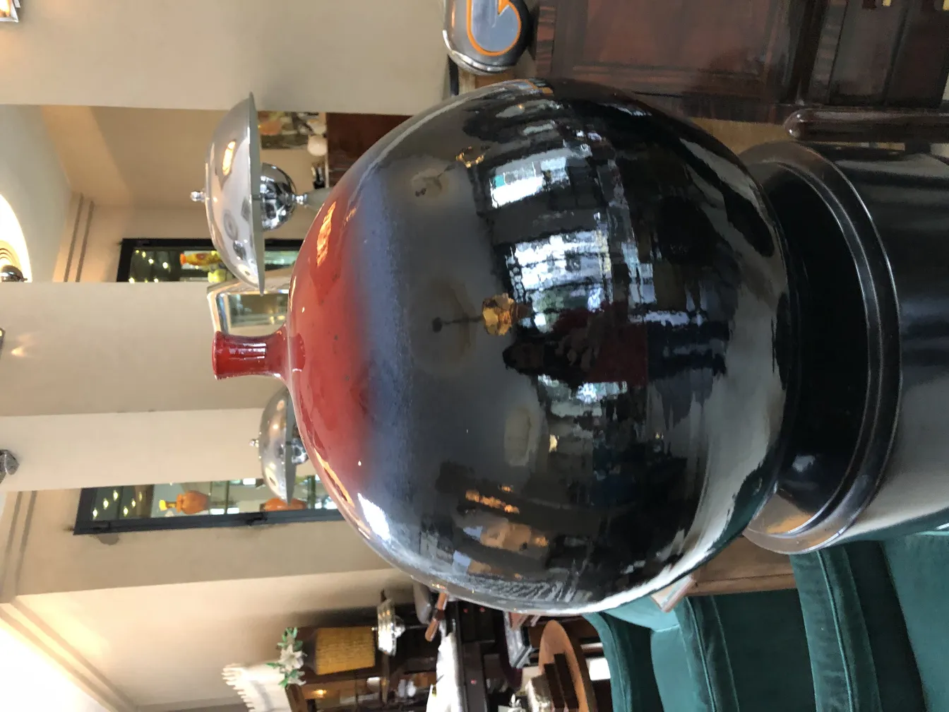 Black sphere with red details, shiny reflections.