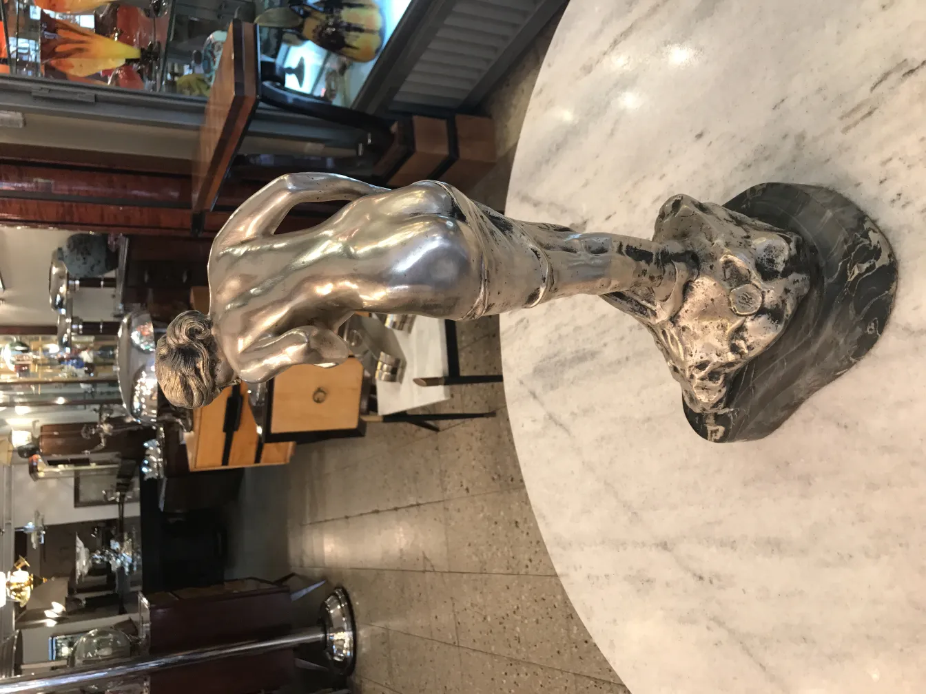 antique human figure sculpture in classic setting