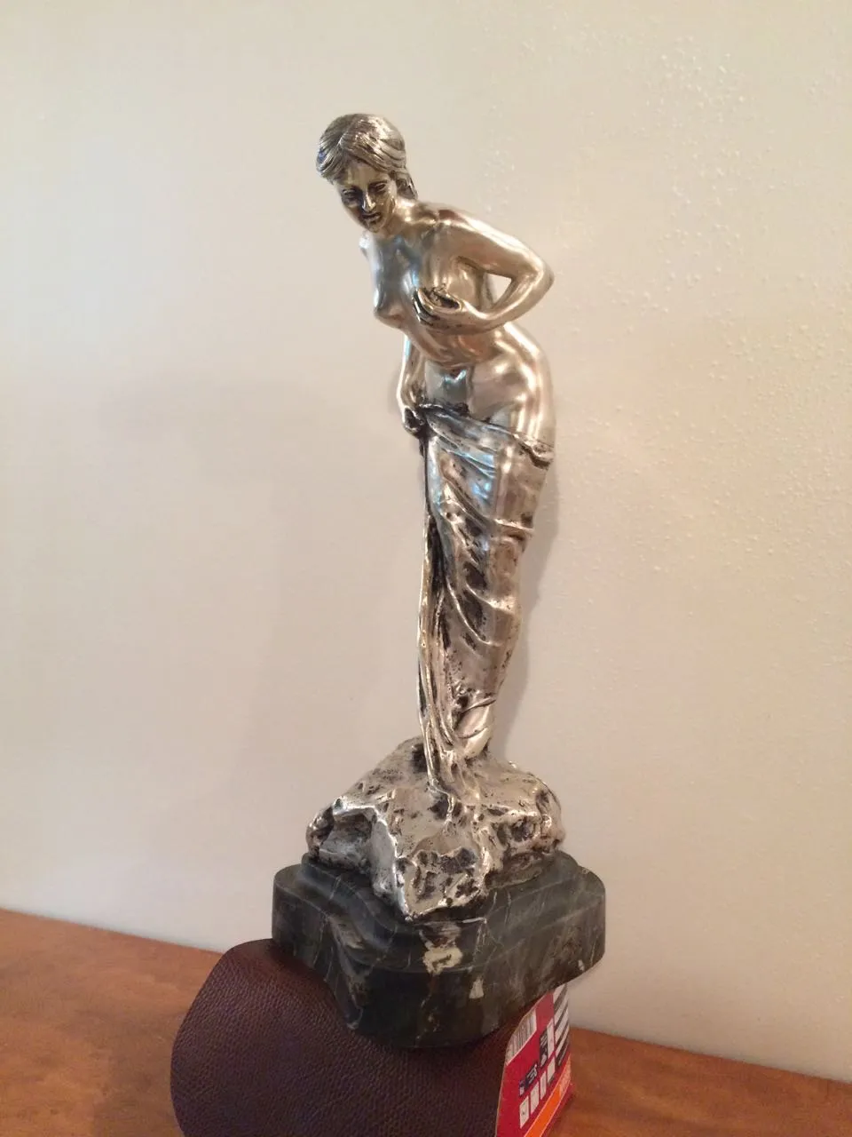 Antique sculpture of a woman, elegant metal figure