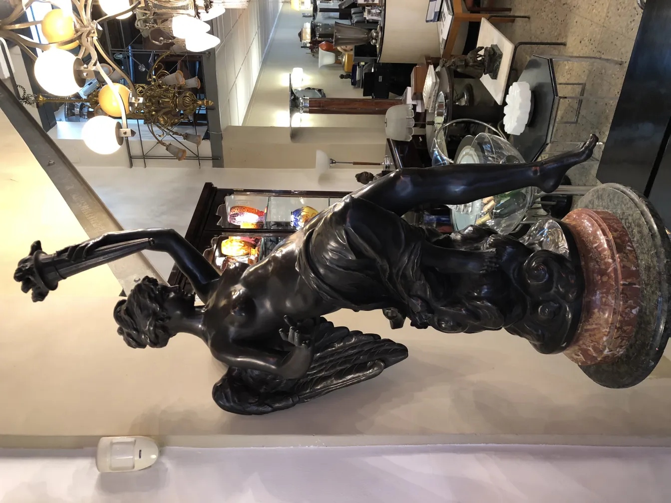 antique sculpture of elegant figure with beer in decorative setting