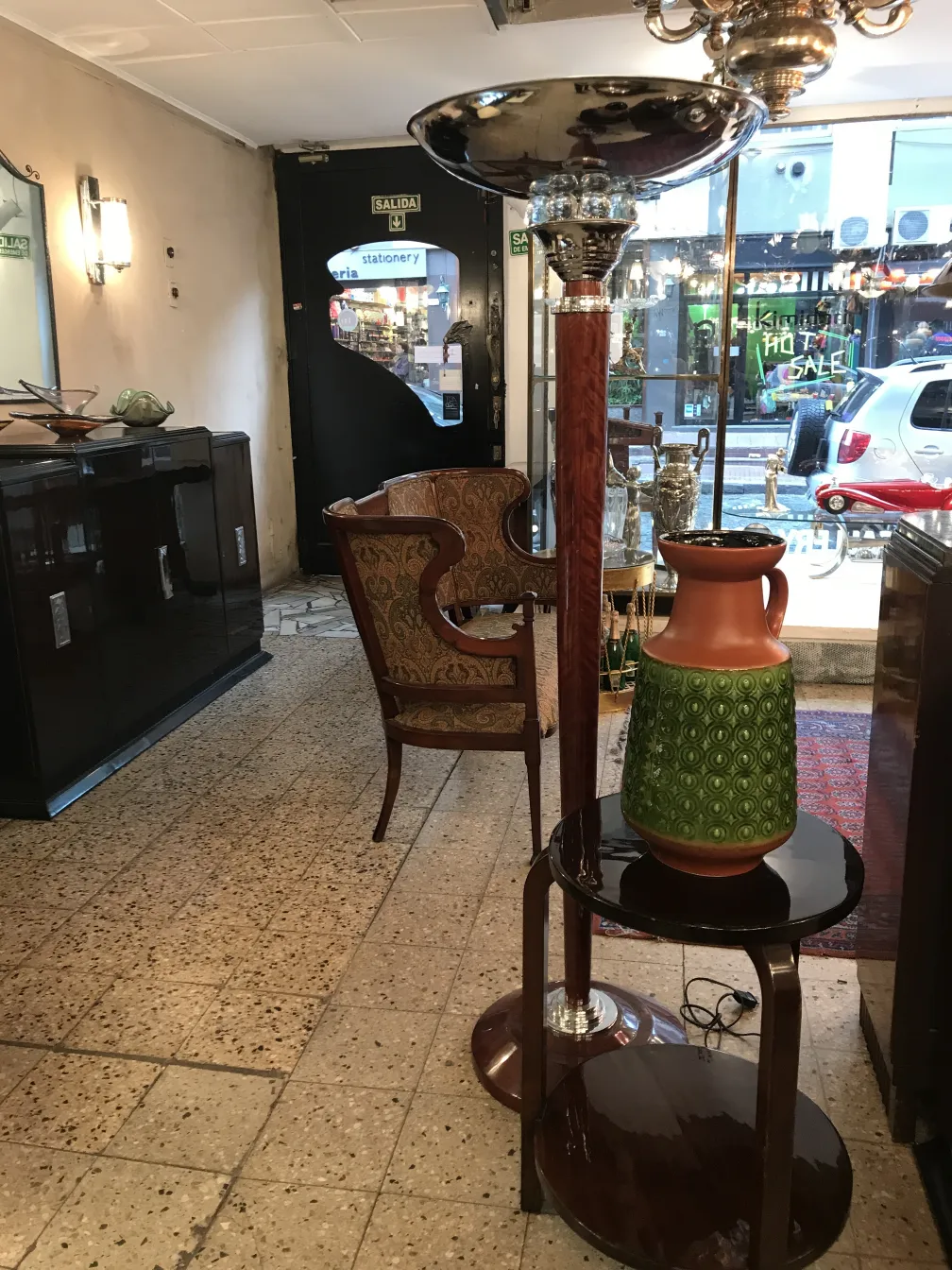 Antique ceramic vase with green and orange design in an antique shop.