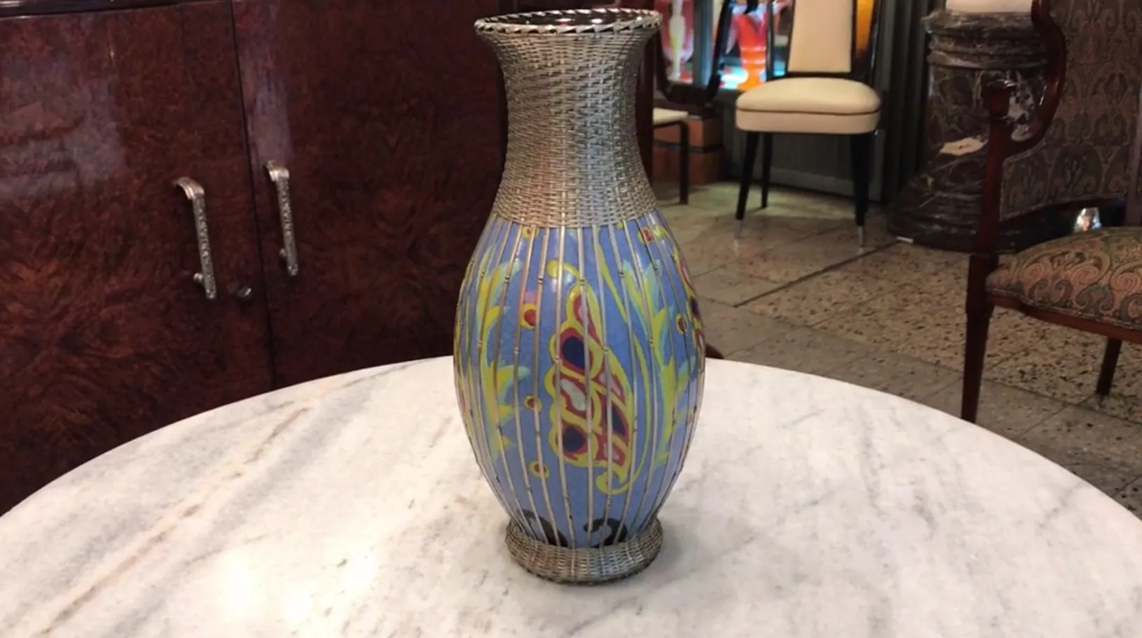 antique ceramic vase with floral design in blue and yellow