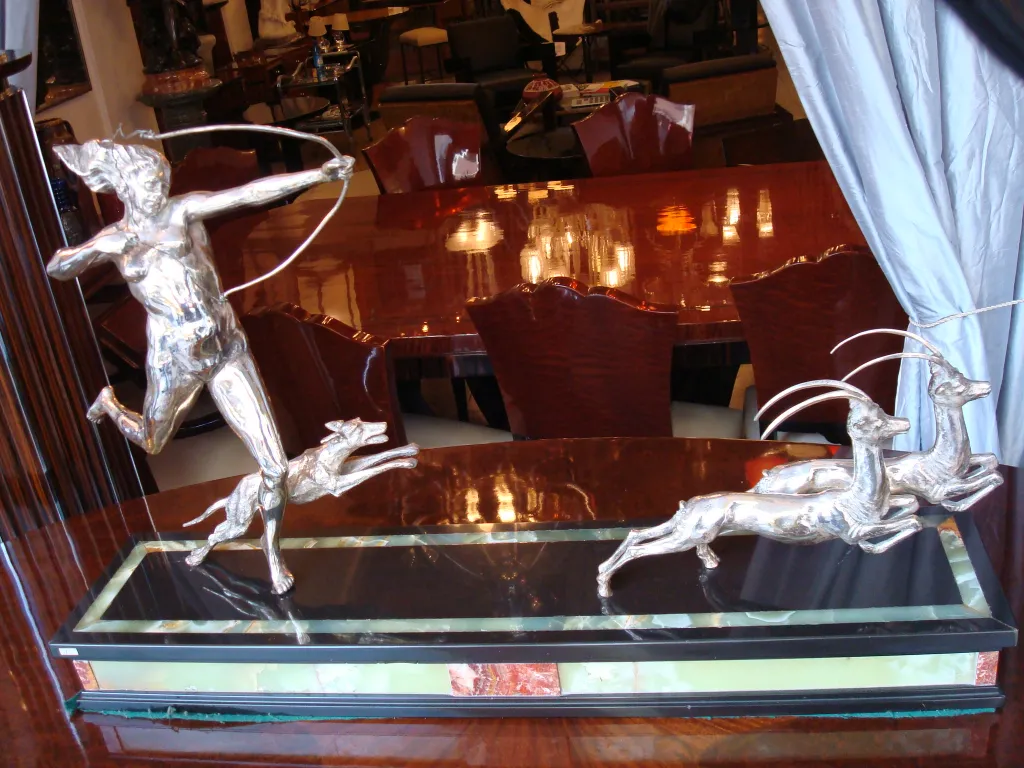 एक प्राचीन मूर्तिकला जिसमें शिकारी और दौड़ते हिरण हैं