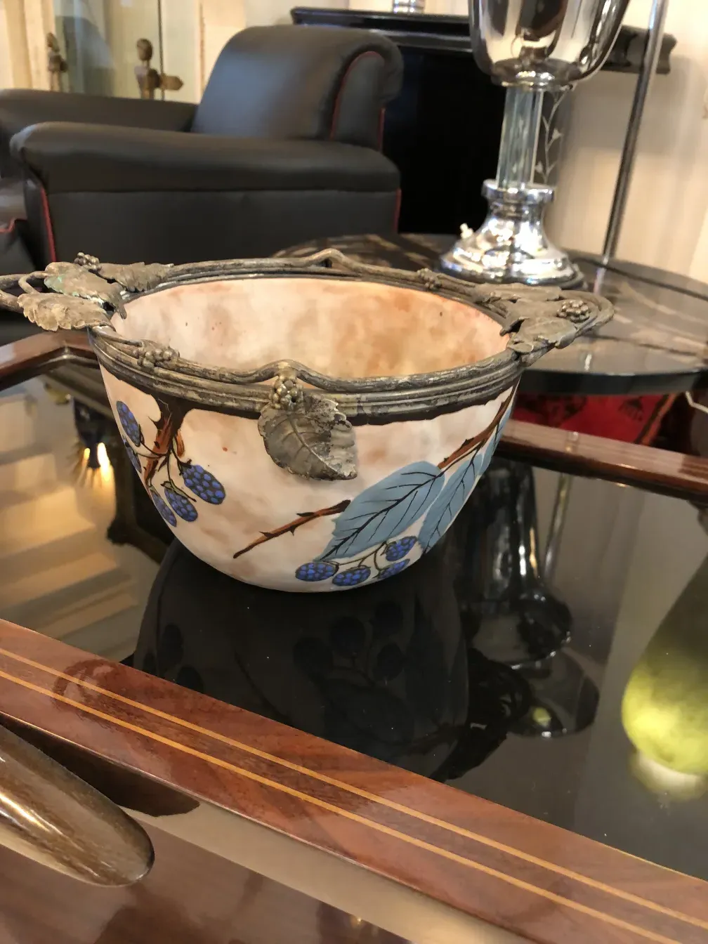 tigela antiga de cerâmica decorada com folhas e frutos em um ambiente elegante