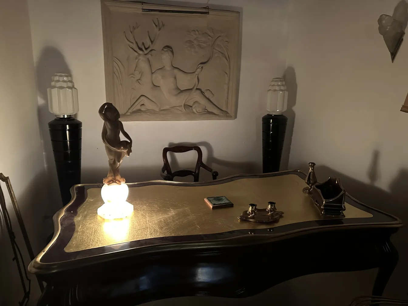 Ancient sculpture of a human figure on an elegant desk.