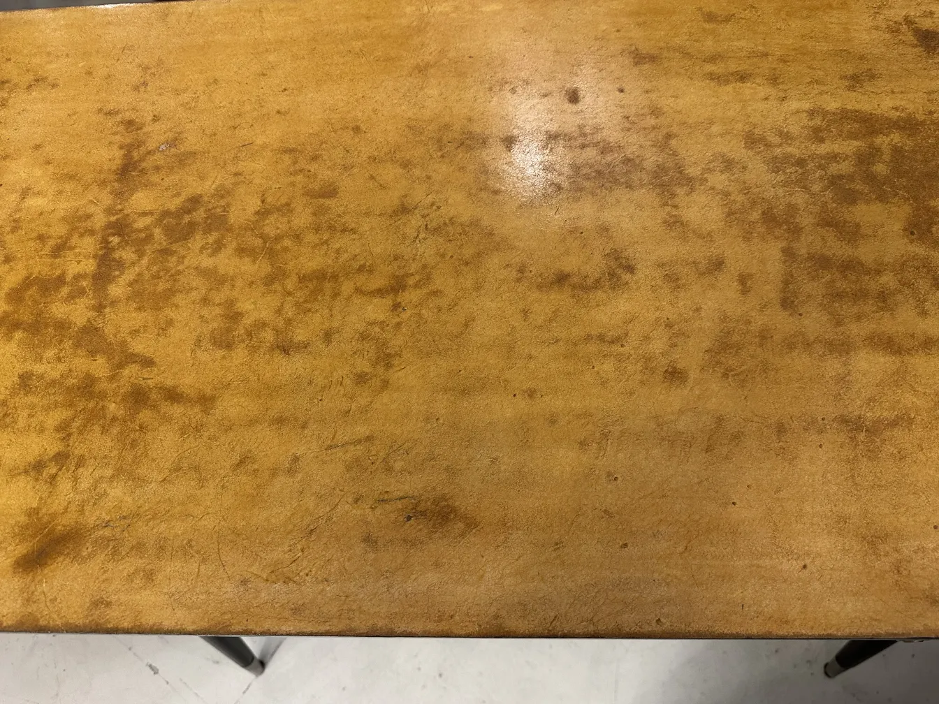 Surface of an antique desk with usage marks