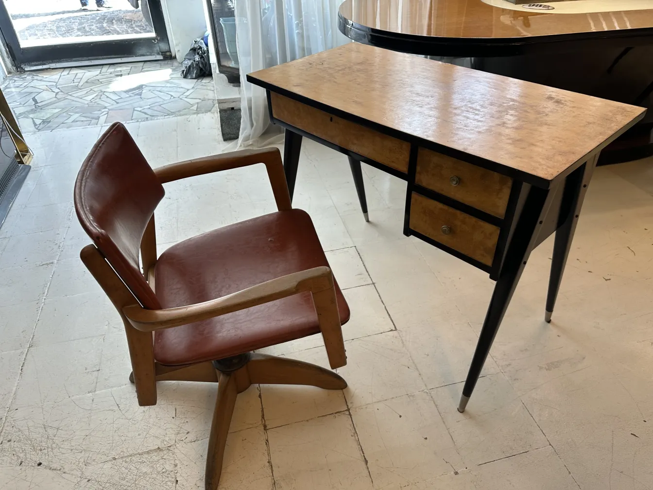 antique desk featuring a simple yet attractive design, two drawers, and a leather chair
