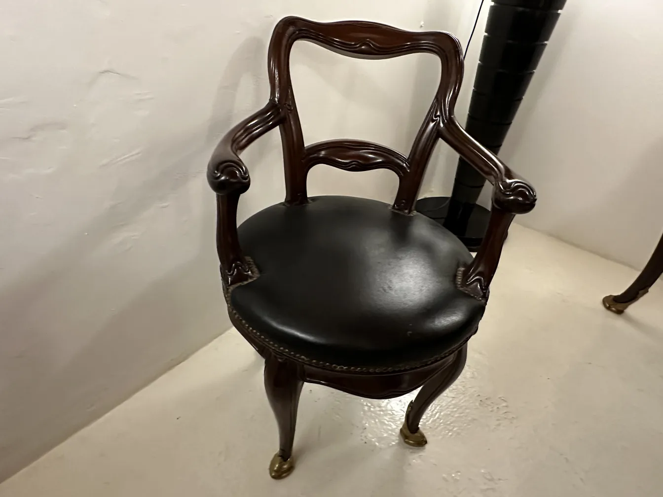 Antique chair with arms and elegant design, in setting