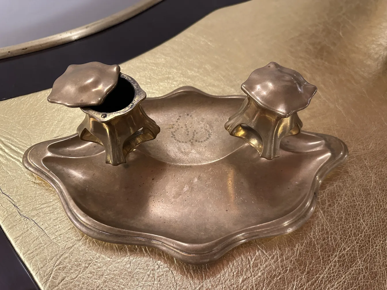 Antique desk with two ornamental pen holders.