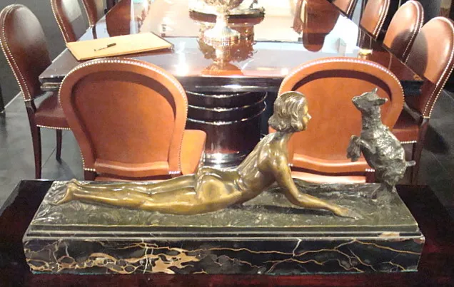 scultura antica in bronzo che rappresenta figura femminile e cane, stile elegante