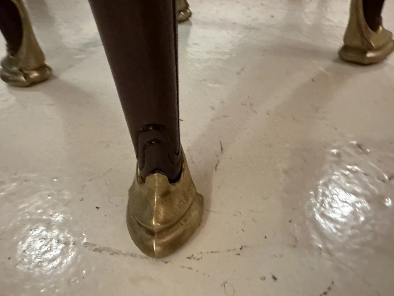 view of an antique desk leg with golden details