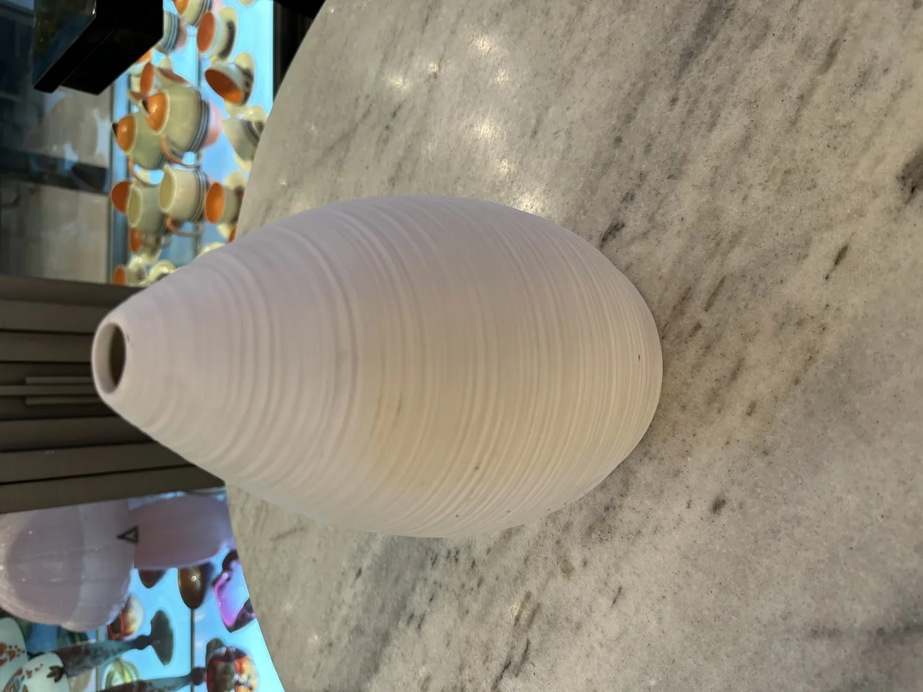 Vase en céramique antique en forme sphérique sur marbre