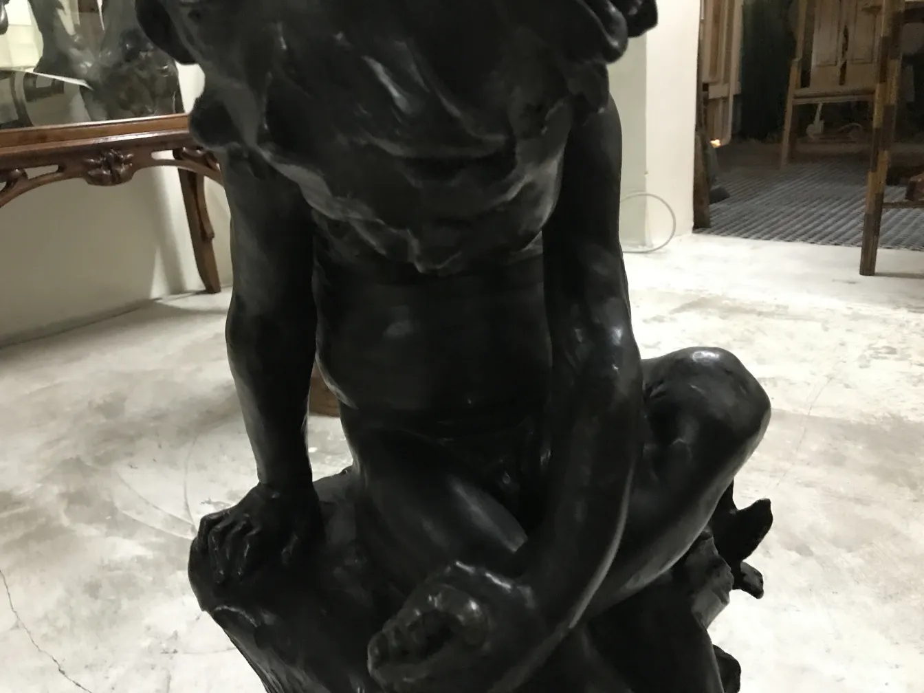 antique sitting figure sculpture in soft environment