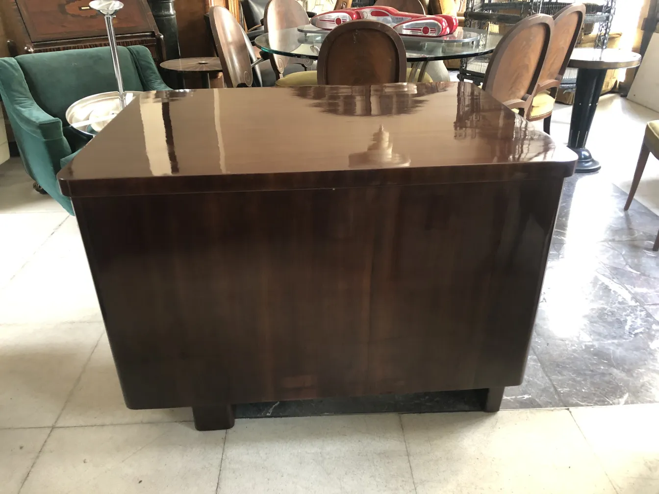 Antique desk with a glossy top set in a cozy environment.