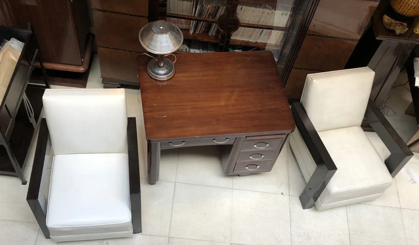 antique wooden desk with white chairs and lamp