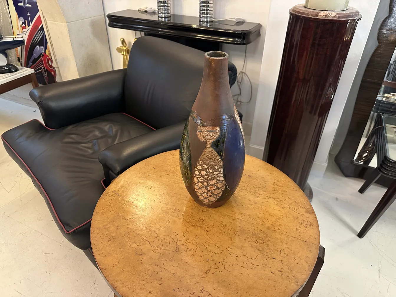 Antique ceramic vase with blue and brown details on table