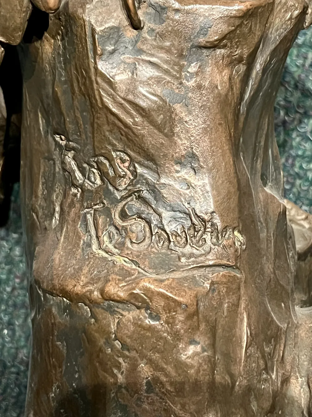 Escultura antiga de artista desconhecido com detalhes visíveis.