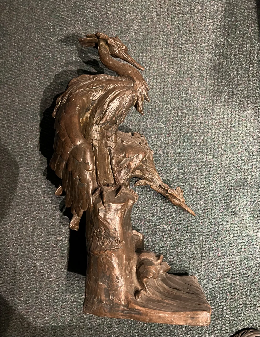 ancient bird sculpture featuring detailed feathers