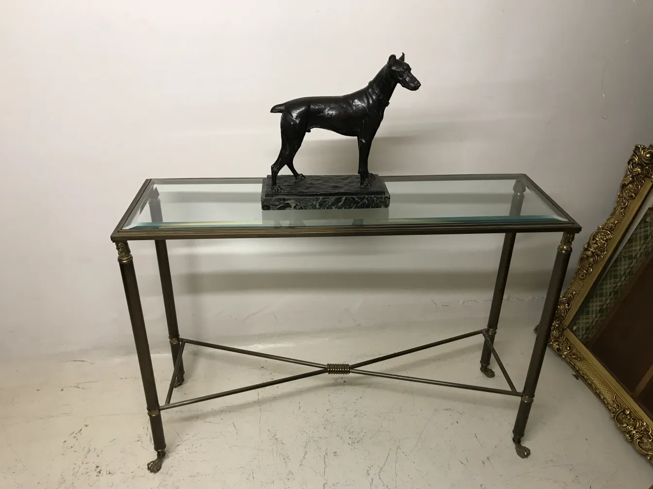 antique dog sculpture on a glass table