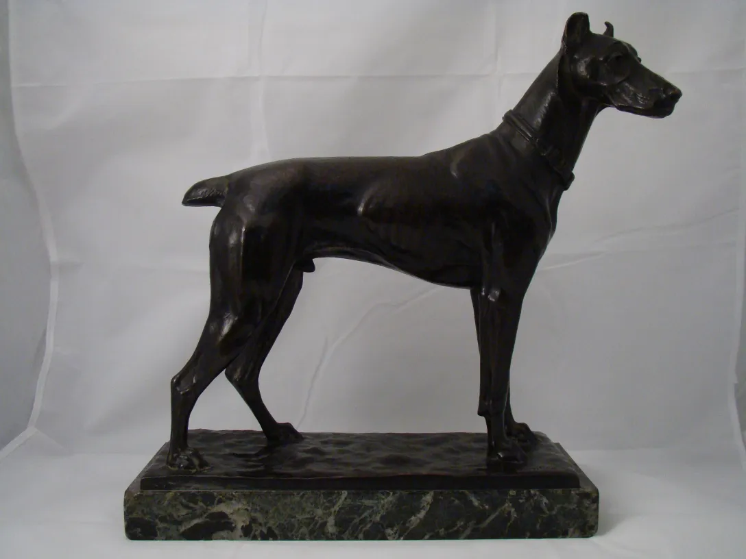 antique sculpture of a dog in an elegant pose