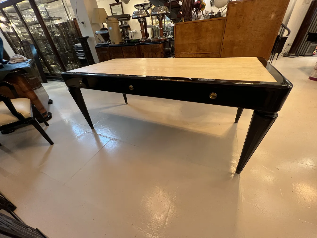 elegant antique desk featuring a stylish design with drawers, in a classic setting