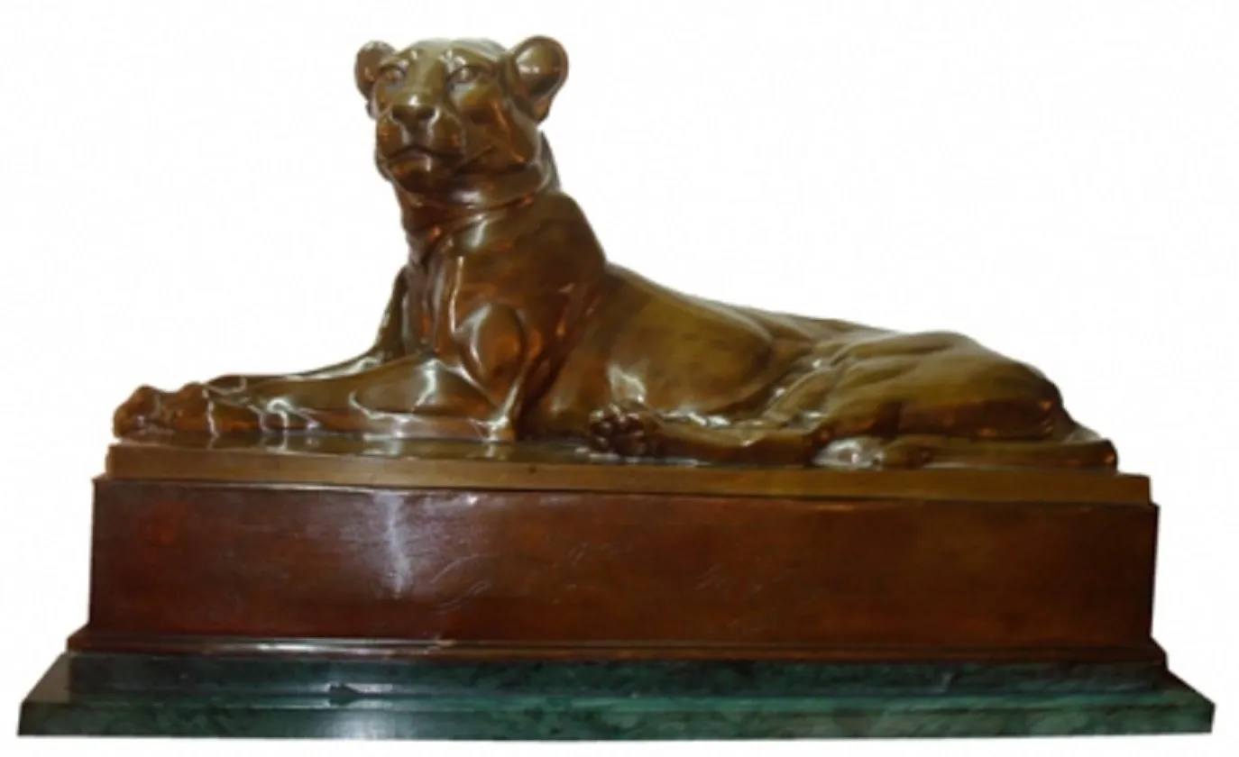 antique sculpture of a lion in a calm position on base