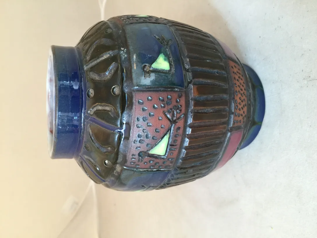 Antique decorative ceramic vase with vibrant textures and colors, perfect for decor.