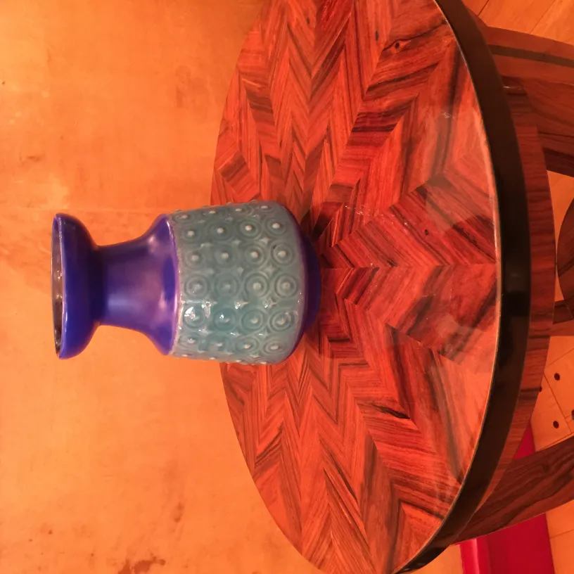 Antique blue ceramic vase with decorative texture.