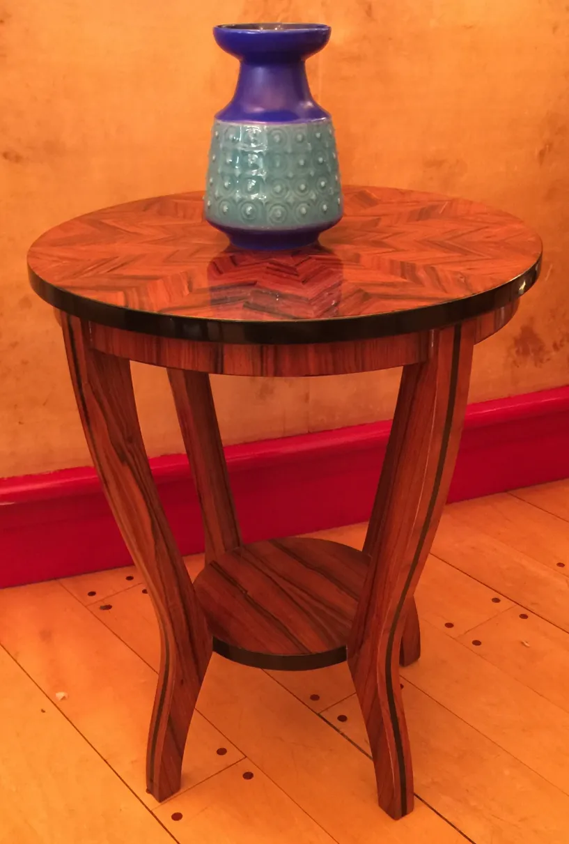 Antique decorative ceramic on round wooden table.