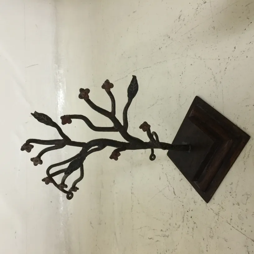 antique sculpture featuring branches and decorative flowers