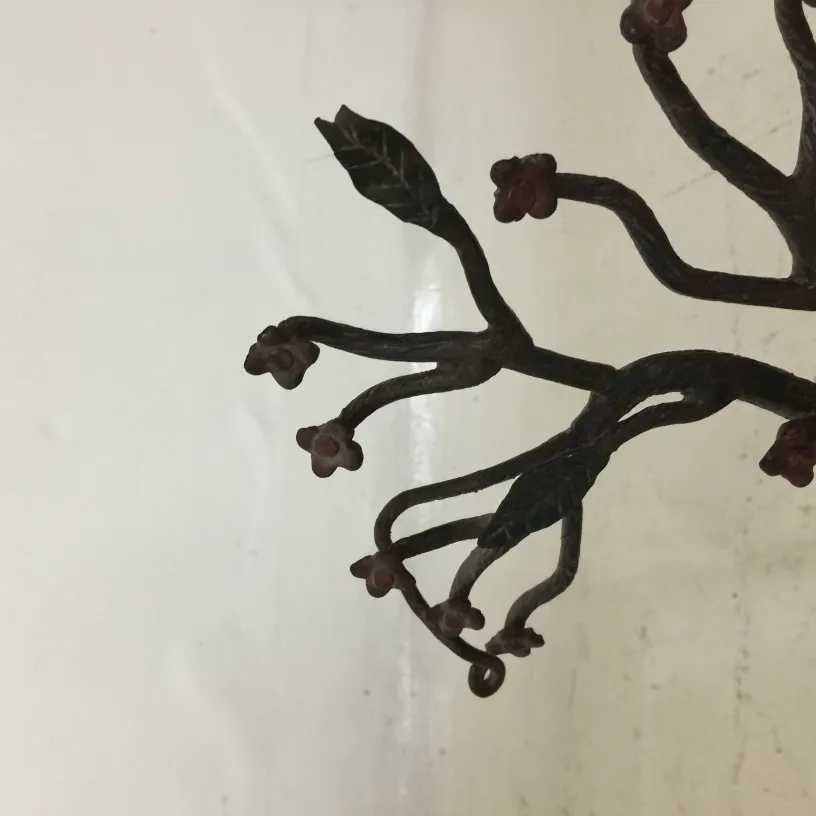 ancient sculpture featuring decorative branches and flowers