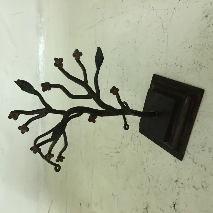 antique sculpture of branches with floral details on base
