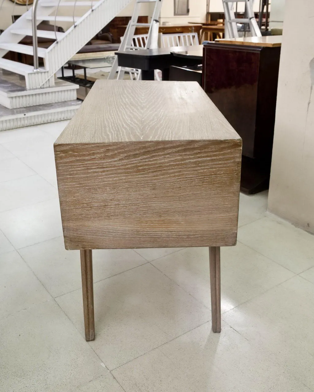 Antique desk with wooden legs, set in an antique environment