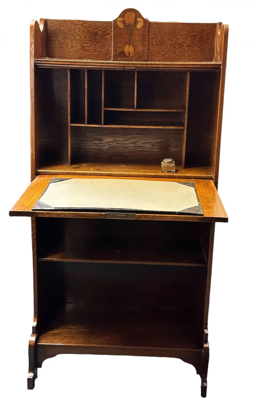 antique desk featuring a decorative top and compartments