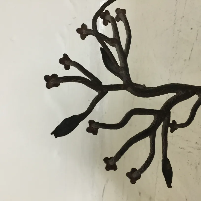 antique sculpture featuring intricate branch and flower design