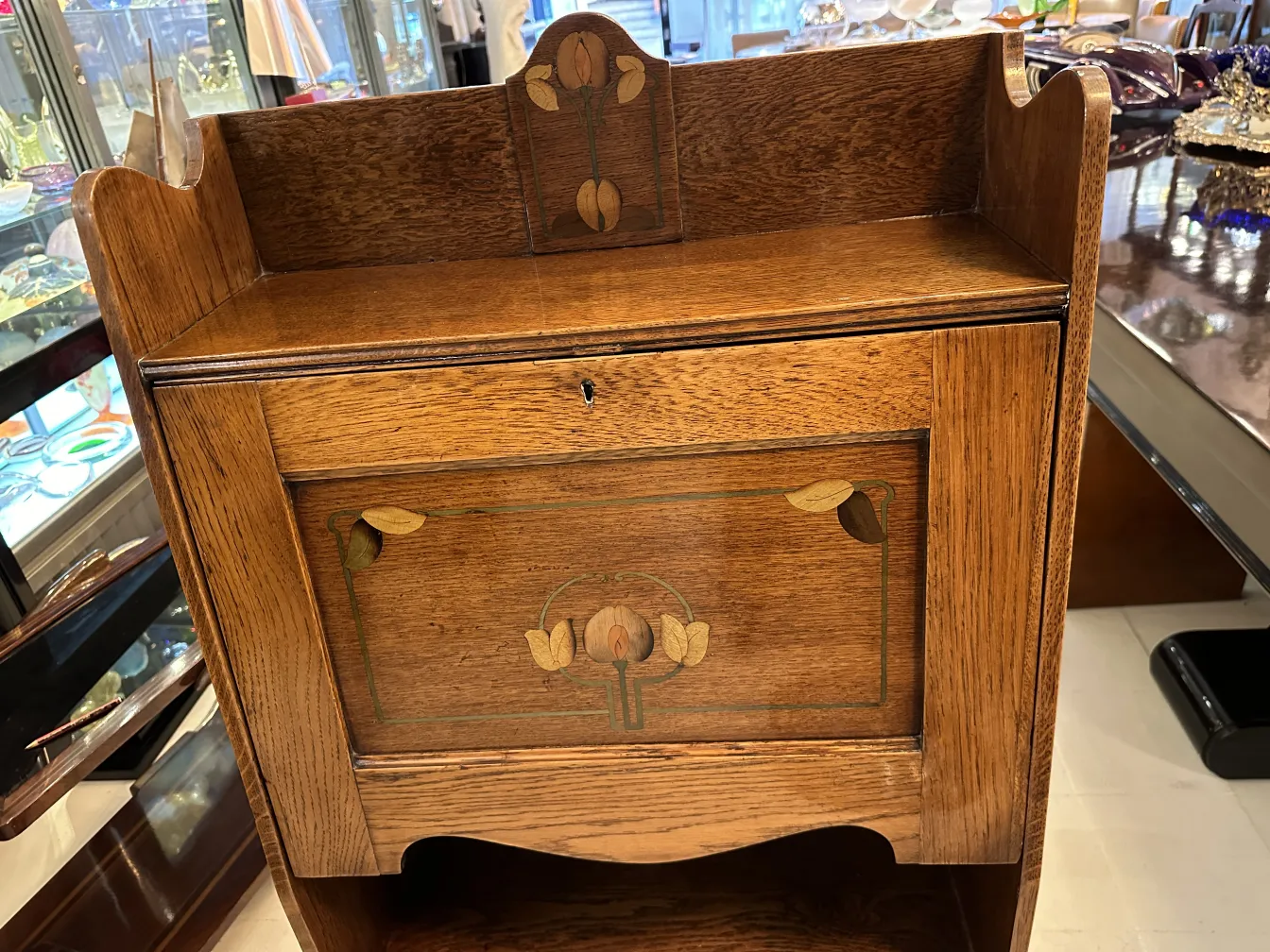 Antique desk featuring decorative design on the front.